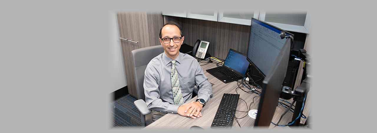 SUNY Canton Associate Professor Kambiz Ghazinour at his desk