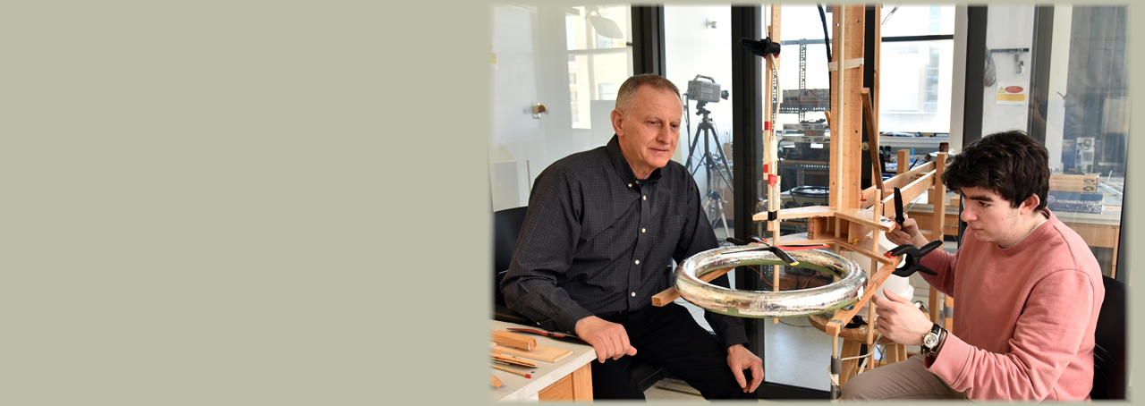 SUNY Oswego's electrical and computer engineering professor Adrian Ieta and student in lab.