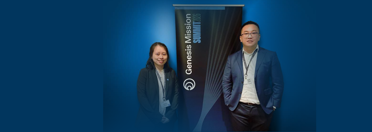 University at Buffalo faculty members Yinyin Ye (left) and Jiayu Peng (right) standing by the Genesis Mission Summit 2026 banner