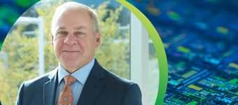 NY Creates President and CEO Dave Anderson on a background of a high-magnification view of an etched silicon wafer used in semiconductor manufacturing