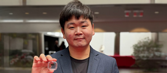 Assistant professor Hyeongrak Choi holds integrated quantum sensors that combine CMOS electronics with diamond color centers