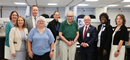 Group photo of local hospital leaders with Senator Schumer at his visit to Alfred State and his touring of nursing and healthcare labs.