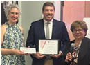 Binghamton University Assistant Professor Daniel S. Reynolds (center) accepting the Breast Cancer Coalition’s Sylvia Cappellino Breast Cancer Research Facutly grant pictured with Executive Director Christina Thompson, left, and Research Administrator Silvia Gambacorta, right