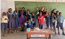 Master of Social Work student Taylor Parsons in a Malawi Children's Mission classroom with a group of children