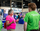 2 people in neon T-Shirts with logo of the NSF Energy Storage Engine at an exhibition