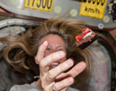Expedition 36 Flight Engineer Karen Nyberg of NASA floats a piece of food in front her in the Node 1 module during meal time