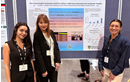 Three researchers stand beside a conference poster presenting a study on using deepfake technology to address anti-transgender prejudice