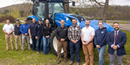 Pictured: Representatives from Capital Tractor, Clinton Tractor, and SUNY Cobleskill Ag & Tech stand with the New Holland T6