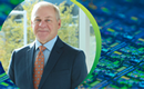 NY Creates President and CEO Dave Anderson on a background of a high-magnification view of an etched silicon wafer used in semiconductor manufacturing