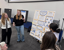 SUNY Poly students in front of a research poster explaining the study they did on NYS Cell phone ban in schools