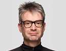 Stony Brook University’s professor Hendrik Hamann in a black turtleneck on a light background