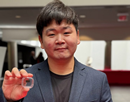 Assistant professor Hyeongrak Choi holds integrated quantum sensors that combine CMOS electronics with diamond color centers
