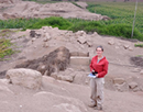 SUNY Oswego anthropology professor Jordan Dalton stands in front of a dig site during groundbreaking research in Chincha Valley in Peru