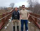 SUNY Polytechnic Institute assistant professor Dr. Leung and research student Seth Walther standing on bridge on campus on a late winter day