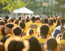 New students wearing numbered race bibs walk to the entry plaza during Opening Convocation at University at Albany