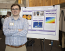 Sophomore Collin Flynn poses with a research poster at ETEC