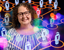Photo of Professor Shira Gabriel in the foreground overlaid on a colorful network graphic showing connected human icons