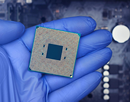 Closeup of a gloved hand holding a semiconductor chip