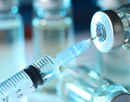 close up of a syringe in a vaccine vial