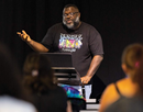 LaGarrett King, conference leader and director of the Center for K–12 Black History and Racial Literacy Education in the Graduate School of Education, at a podium speaking at a previous Teaching Black History Conference