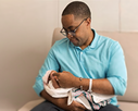 State Senator Zellnor Myrie holding a baby